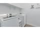 Bright laundry room with modern front-load washer and dryer, ample storage and shelving at 5228 S 106Th Pl, Mesa, AZ 85212