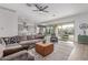 Open-concept living room with a sectional sofa, modern decor, and sliding doors to the outdoor space at 5228 S 106Th Pl, Mesa, AZ 85212