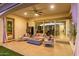 Cozy covered patio with outdoor seating, a fire pit, and sliding glass doors to the house at 5228 S 106Th Pl, Mesa, AZ 85212