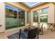 Inviting patio area with comfortable seating, sliding glass doors, and a black and white rug, blending indoor-outdoor living at 5228 S 106Th Pl, Mesa, AZ 85212