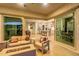 Inviting outdoor living space showcasing a fire pit, comfortable seating, and sliding glass doors at 5228 S 106Th Pl, Mesa, AZ 85212