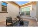 Cozy outdoor patio featuring stylish seating, a patterned rug, and a modern fire pit, perfect for relaxation at 5228 S 106Th Pl, Mesa, AZ 85212
