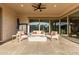 Covered patio with a stylish seating arrangement, a fire pit, and a ceiling fan, creating a perfect outdoor living space at 5228 S 106Th Pl, Mesa, AZ 85212