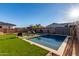 Backyard oasis with a sparkling pool, lush green lawn, and comfortable lounge chairs, ideal for summer enjoyment at 5228 S 106Th Pl, Mesa, AZ 85212