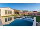 Serene backyard with a luxurious pool, artificial grass, and comfortable lounge chairs, designed for relaxation and enjoyment at 5228 S 106Th Pl, Mesa, AZ 85212
