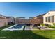 Beautiful backyard with a refreshing pool, artificial grass, and stylish patio furniture, designed for outdoor relaxation at 5228 S 106Th Pl, Mesa, AZ 85212