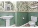 Charming powder room featuring unique cactus-themed wallpaper, pedestal sink, and coordinating fixtures at 5228 S 106Th Pl, Mesa, AZ 85212