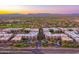 Stunning aerial view of condo community with golf course and mountain views at sunset, offering serene desert living at 5450 E Deer Valley Dr # 1195, Phoenix, AZ 85054