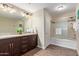Bathroom featuring a double vanity, stylish dark cabinets, and glass-enclosed shower and tub combination at 5450 E Deer Valley Dr # 1195, Phoenix, AZ 85054