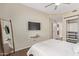 Modern bedroom with mounted TV, full-length mirror, and a walk-in closet, offering style and functionality at 5450 E Deer Valley Dr # 1195, Phoenix, AZ 85054