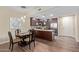 Open-concept kitchen with modern dark cabinetry, stainless steel appliances, and a dining area with stylish lighting at 5450 E Deer Valley Dr # 1195, Phoenix, AZ 85054