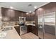 Well-equipped kitchen with stainless steel appliances, mosaic backsplash, and ample cabinet space, ideal for cooking at 5450 E Deer Valley Dr # 1195, Phoenix, AZ 85054