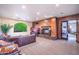 Comfortable lounge area with a fireplace, leather sofa, and large windows at 5450 E Deer Valley Dr # 1195, Phoenix, AZ 85054