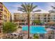 Relaxing pool with lounge chairs, lush landscaping, and a large palm tree at 5450 E Deer Valley Dr # 1195, Phoenix, AZ 85054