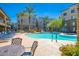 Resort-style pool area with ample seating, lush landscaping, and a clear blue sky at 5450 E Deer Valley Dr # 1195, Phoenix, AZ 85054
