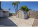 Backyard shed and concrete patio area with privacy fence at 5944 W Greenbriar Dr, Glendale, AZ 85308