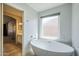 Bathroom displaying a freestanding tub by a window offering lots of natural light at 5944 W Greenbriar Dr, Glendale, AZ 85308