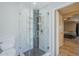 Modern tiled shower stall with glass door in bright bathroom adjacent to the bedroom at 5944 W Greenbriar Dr, Glendale, AZ 85308