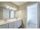 Bathroom showcasing double sinks, vanity, and a separate area for the bathtub and toilet at 5944 W Greenbriar Dr, Glendale, AZ 85308