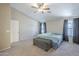 Bedroom features plush carpet, ceiling fan, and a cozy bed with natural light from two windows at 5944 W Greenbriar Dr, Glendale, AZ 85308