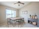 Bright dining room featuring neutral tones, a modern ceiling fan and stylish furnishings under natural light at 5944 W Greenbriar Dr, Glendale, AZ 85308