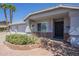 Close-up of the home's entrance showing decorative black metal security door and brick-lined flower bed at 5944 W Greenbriar Dr, Glendale, AZ 85308