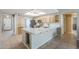 Bright, modern kitchen features light wood cabinets, white countertops, stainless steel appliances, and tile flooring at 5944 W Greenbriar Dr, Glendale, AZ 85308