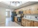 Well-equipped kitchen showcases stainless steel appliances, light wood cabinets, and neutral tile floors at 5944 W Greenbriar Dr, Glendale, AZ 85308