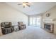 Spacious living room features a brick fireplace, carpet flooring, and sliding glass doors to the backyard at 5944 W Greenbriar Dr, Glendale, AZ 85308