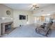 Cozy living room with a brick fireplace, neutral carpet, and ample natural light at 5944 W Greenbriar Dr, Glendale, AZ 85308