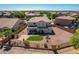 Aerial view of home and yard with desert landscaping, stone patio, putting green, and perimeter fence at 5973 S Legend Dr, Gilbert, AZ 85298