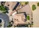 Aerial view of the home showcasing the desert landscaping, brown roof and proximity to nearby homes at 5973 S Legend Dr, Gilbert, AZ 85298