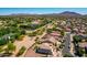 Aerial view of the community showcasing the desert landscaping, proximity to nearby farmland, and mountain views at 5973 S Legend Dr, Gilbert, AZ 85298