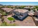 Aerial view of the two-story home featuring a low-maintenance yard, backyard turf, and perimeter fencing at 5973 S Legend Dr, Gilbert, AZ 85298
