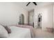 Cozy bedroom with neutral carpet, ceiling fan, walk-in closet, and simple decor at 5973 S Legend Dr, Gilbert, AZ 85298