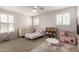 Bright bedroom with carpet, neutral paint, ceiling fan and multiple windows at 5973 S Legend Dr, Gilbert, AZ 85298
