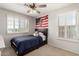 Comfortable bedroom with carpet, ceiling fan and baseball themed decor at 5973 S Legend Dr, Gilbert, AZ 85298