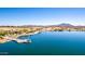 Aerial view of the lake in the community, showcasing a fishing pier and mountain views at 5973 S Legend Dr, Gilbert, AZ 85298