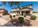 Inviting two-story home with a manicured lawn and a cozy front porch at 5973 S Legend Dr, Gilbert, AZ 85298