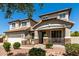 Attractive two-story home featuring stone accents and a well-maintained front yard at 5973 S Legend Dr, Gilbert, AZ 85298