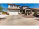 Charming home with desert landscaping, an attached garage, and an inviting front porch at 5973 S Legend Dr, Gilbert, AZ 85298