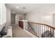 Upstairs hallway featuring neutral carpet, natural light, and built-in storage at 5973 S Legend Dr, Gilbert, AZ 85298