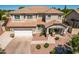 Aerial view of a two-story home showcasing the front yard, desert landscaping, and attached two-car garage at 5973 S Legend Dr, Gilbert, AZ 85298