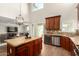 Gourmet kitchen boasting granite countertops, an island with seating, and modern stainless steel appliances at 5973 S Legend Dr, Gilbert, AZ 85298
