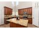 Bright kitchen with wooden cabinetry, granite countertops, stainless steel appliances, and center island at 5973 S Legend Dr, Gilbert, AZ 85298