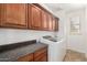 Well lit laundry room with tile floor, cabinets and newer appliances at 5973 S Legend Dr, Gilbert, AZ 85298