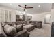Spacious living room featuring plush sectional sofa, neutral carpet, and recessed lighting at 5973 S Legend Dr, Gilbert, AZ 85298