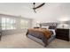 Bright main bedroom with neutral carpet, ceiling fan, and plantation shutters create a serene retreat at 5973 S Legend Dr, Gilbert, AZ 85298