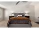 Serene main bedroom with tufted headboard, nightstands, neutral carpet, and ceiling fan at 5973 S Legend Dr, Gilbert, AZ 85298