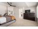 Spacious main bedroom with ceiling fan, neutral carpet, and en-suite bathroom at 5973 S Legend Dr, Gilbert, AZ 85298